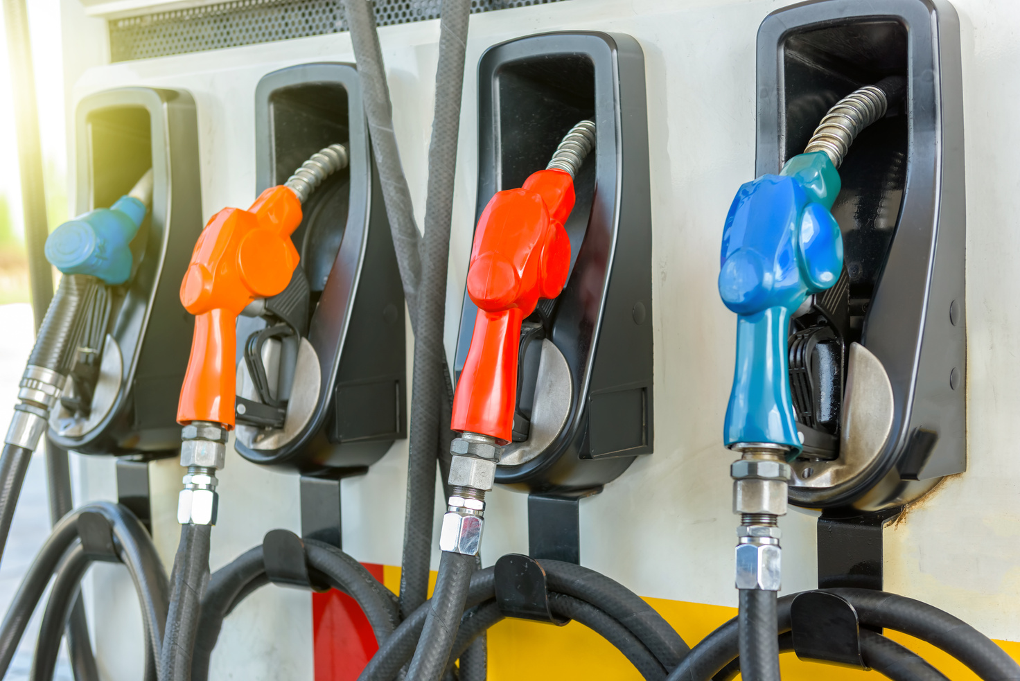Colorful Petrol pump filling nozzles at gas station
